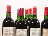 several bottles of wine are lined up in a row on a table