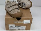 pair of baby shoes in a box on a white surface