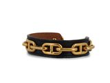 a black leather bracelet with a gold chain on it