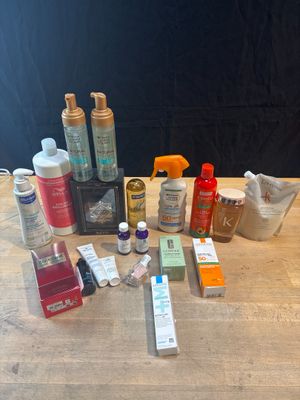 many different types of paint and glues on a wooden table