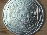 a silver coin that is on a wooden table