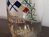 a glass with a design on it sitting on a table