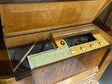a wooden cabinet with a radio inside of it