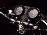a close up of a motorcycle with a speedometer on the handlebars