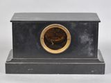 an image of a clock sitting on top of a black table