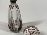 two glass vases sitting next to each other on a white surface