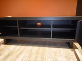 a black entertainment center with a ball in the middle of it