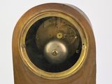 a wooden clock with a metal face on a white background