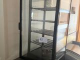 an image of a refrigerator with a glass door in a room