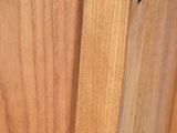 a close up of a wooden cabinet door with a latch on it