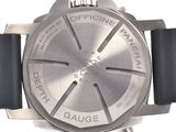 a close up of a watch on a white surface