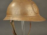 an old helmet is on a clear stand against a gray background