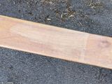 a wooden bench that is sitting on the ground