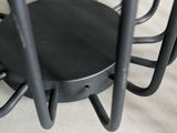 a black chair that is sitting on a white sheet