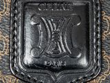 an image of a close up of a black leather bag with a logo on it
