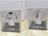 two pictures of a real madrid shirt in a display case