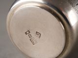 a close up of a silver cup on a table