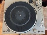 a turntable that is sitting on top of a wooden table
