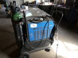 a blue machine that is sitting in a garage
