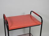 an image of a metal cart with a red tray on it