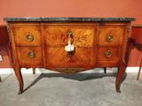 a very large wooden cabinet with a marble top