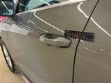 a close up of a car door handle with a sticker on it