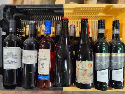 many bottles of wine sitting on a shelf next to each other