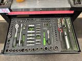 many tools in a tool box on the floor