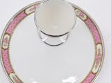 an empty cup and saucer sitting on top of a saucer