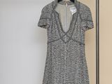 the dress is hanging on a clothes rack in the room