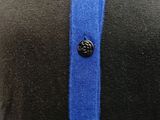 a close up of a person ' s shirt with a button on it
