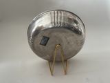 an image of a silver metal object with a hairpin on it
