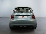 the back end of a small car in a room with a white wall