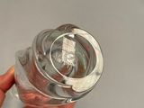 a person holding a glass of water in their hand