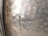 a close up of a metal object with a name engraved on it