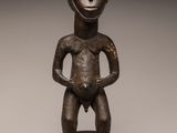 an image of a bronze statue of a man standing on top of a wooden base