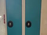 two blue lockers in a room with a white wall