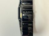 a close up of a wrist watch on a white surface