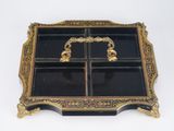 a black and gold tray with a gold handle on it