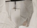 a white shirt hanging on a hanger in a room