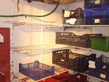 a room with a lot of crates and shelves
