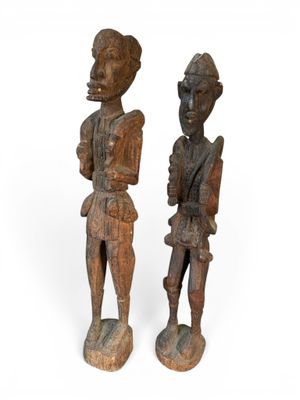 pair of carved wooden figures of a man and a woman