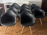 six black eames chairs with wooden legs and a radiator radiator radiator radiator radiator radiator radiator ra