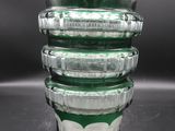 a stack of glass containers sitting on top of a table