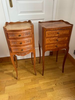 two wooden tables with drawers on them in a room