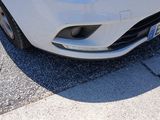 a white car that is parked on the side of the street