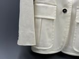 an image of a white jacket hanging on a hanger