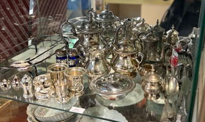 une vitrine en verre contenant des objets en argent