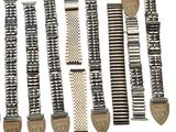 several different types of watch bands are lined up on a white surface