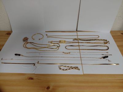 a lot of gold necklaces and bracelets on a table